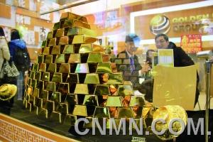 參展的金行在現(xiàn)場展臺用金磚壘出小“金字塔”，吸引了眾多投資者的目光。